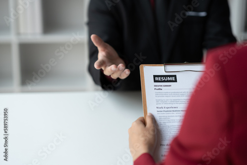 Human resources staff explaining the details of the resume filling out on the chart to the person applying for a job interview with the company. employee job application concept.