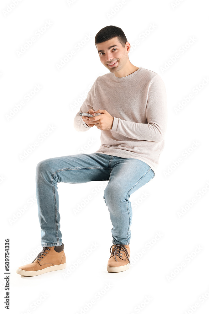 Handsome guy using mobile phone on white background