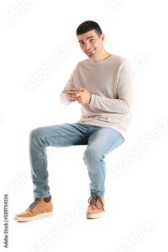 Handsome guy using mobile phone on white background