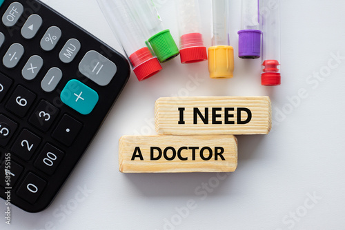 TEXT I NEED A DOCTOR and medical test tubes with flowers on a white background