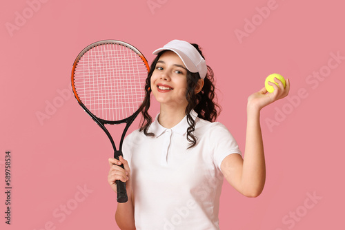 Teenage tennis player with racket and ball on pink background © Pixel-Shot