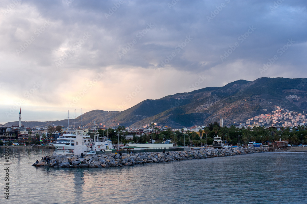 Fototapeta premium Beautiful view on a town, mountains, sea and ships in Alanya port, Turkey