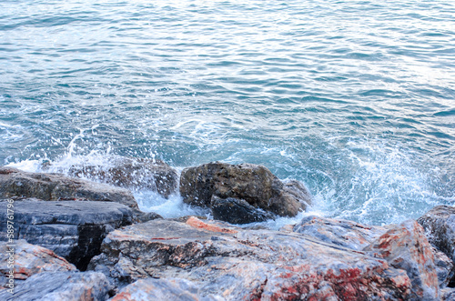 Sea waves crashing and spashes on stones alanya turkey photo