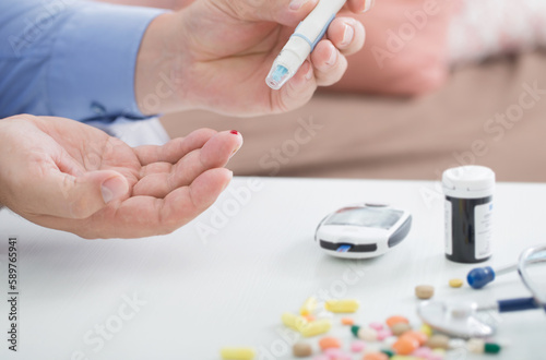 medicine, diabetes, glycemia, health care and people concept - close up of male finger with test stripe