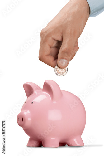 Businessman putting coin into the piggy bank
