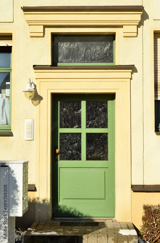 View of beautiful building with green wooden door