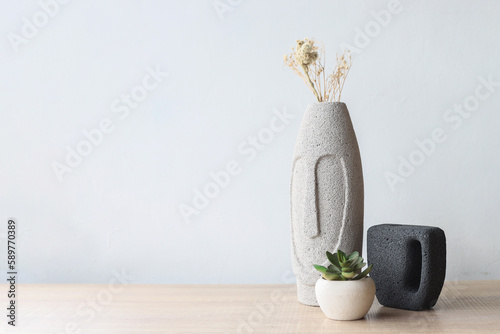 Creative flat lay of wood table and minimalist room with a succulent, vase flowers. Landscape top view copy space.