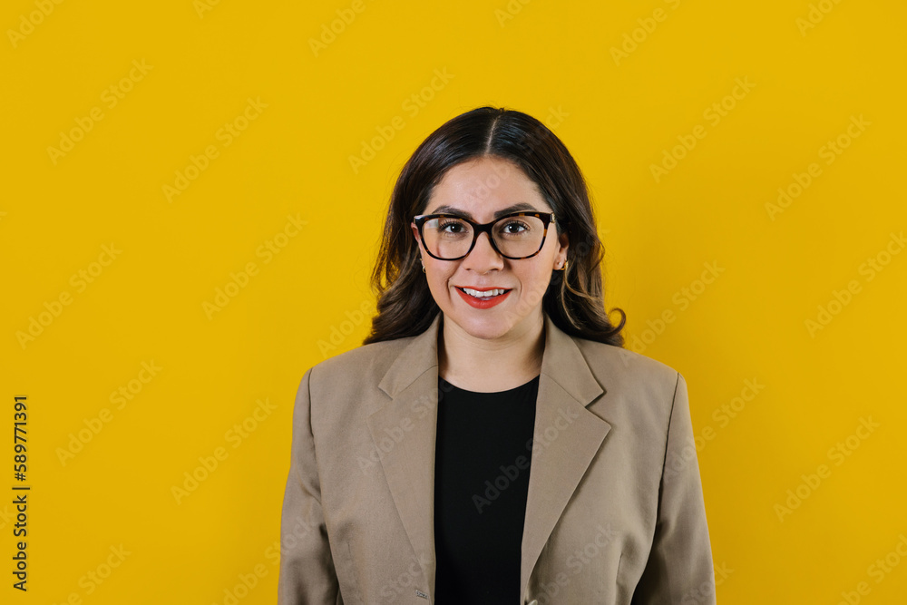 young latin businesswoman portrait posing isolated over yellow background in Mexico Latin America