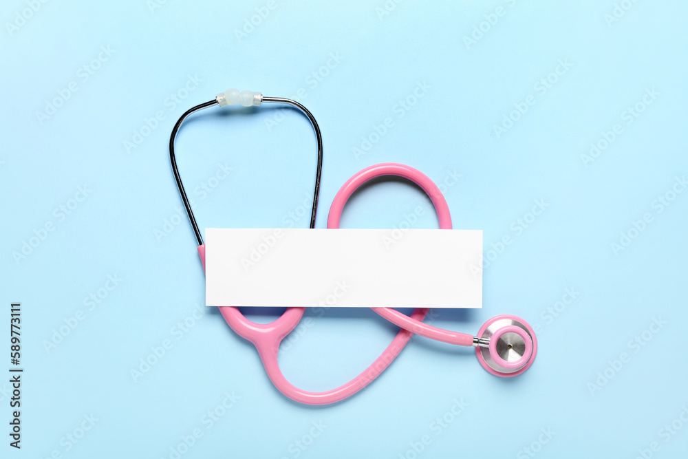 Obraz premium Blank sheet of paper and stethoscope on color background. Melanoma concept