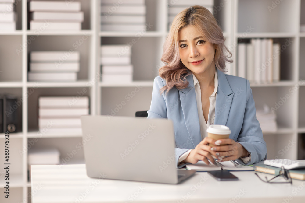 Portrait of Asian business woman holding coffee cup with work in workplace office Business documents money financial planning concept Portrait of Asian business woman holding coffee cup with work in workplace office Business documents money financial planning concept