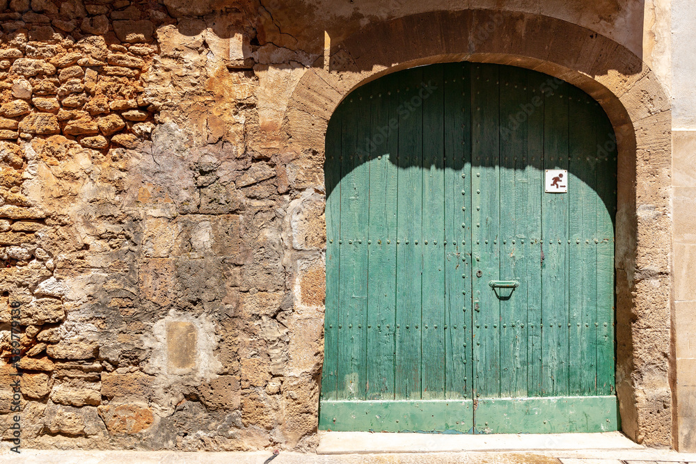 A green vintage wooden door.