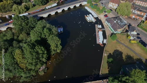 Aerial view orbiting Clopton bridge and river Avon waterfront boat house, Stratford upon Avon photo