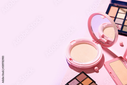 Powder with eyeshadows on pink background, closeup