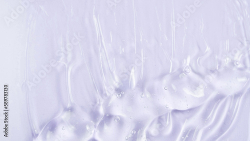 Transparent clear skincare cream with bubbles on white background. Transparent colored cosmetic product close up