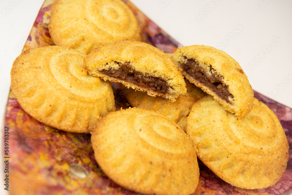 Traditional eid maamoul or mamoul cookies with dates, nuts, and jam, Arabic sweets for Aid al-Fitr and easter, High quality photo