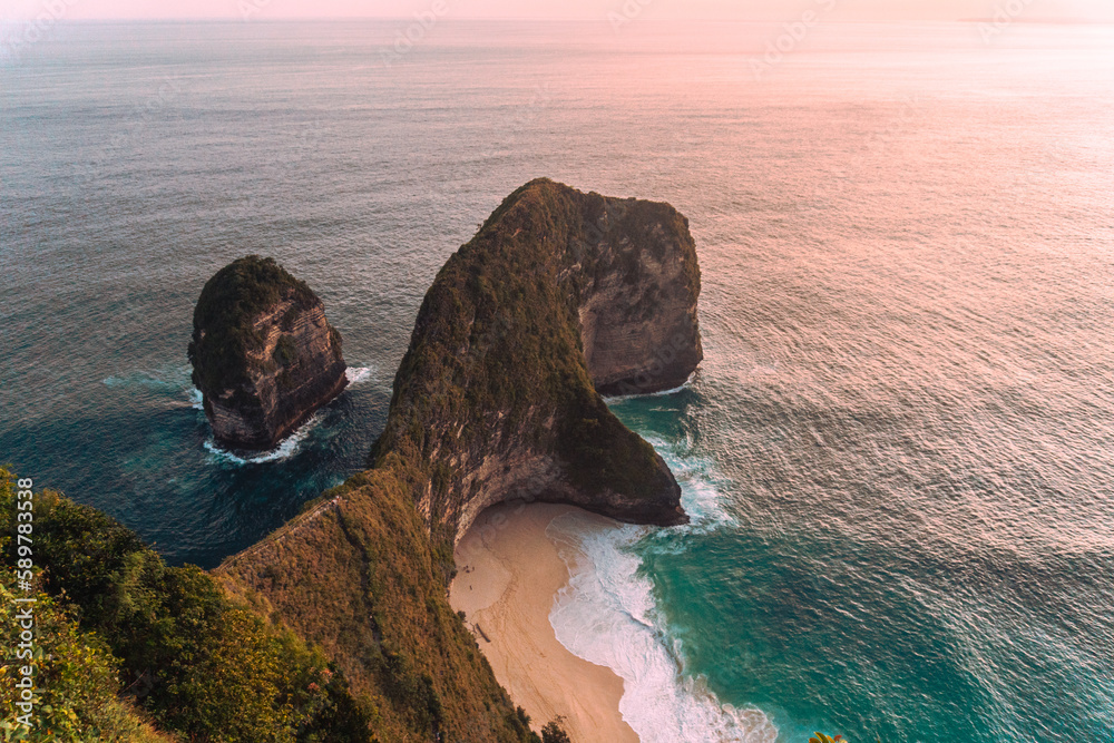 Coast at sunset, beautiful cliffs and beach, ocean, Nusa Penida, Indonesia, tropical island.