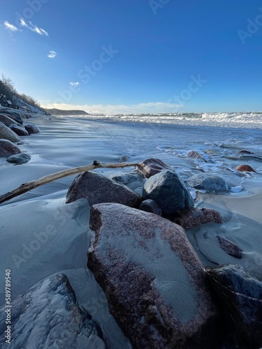 A sandy beach stretching into the distance with marble stones and extraordinarily beautiful landscapes.
