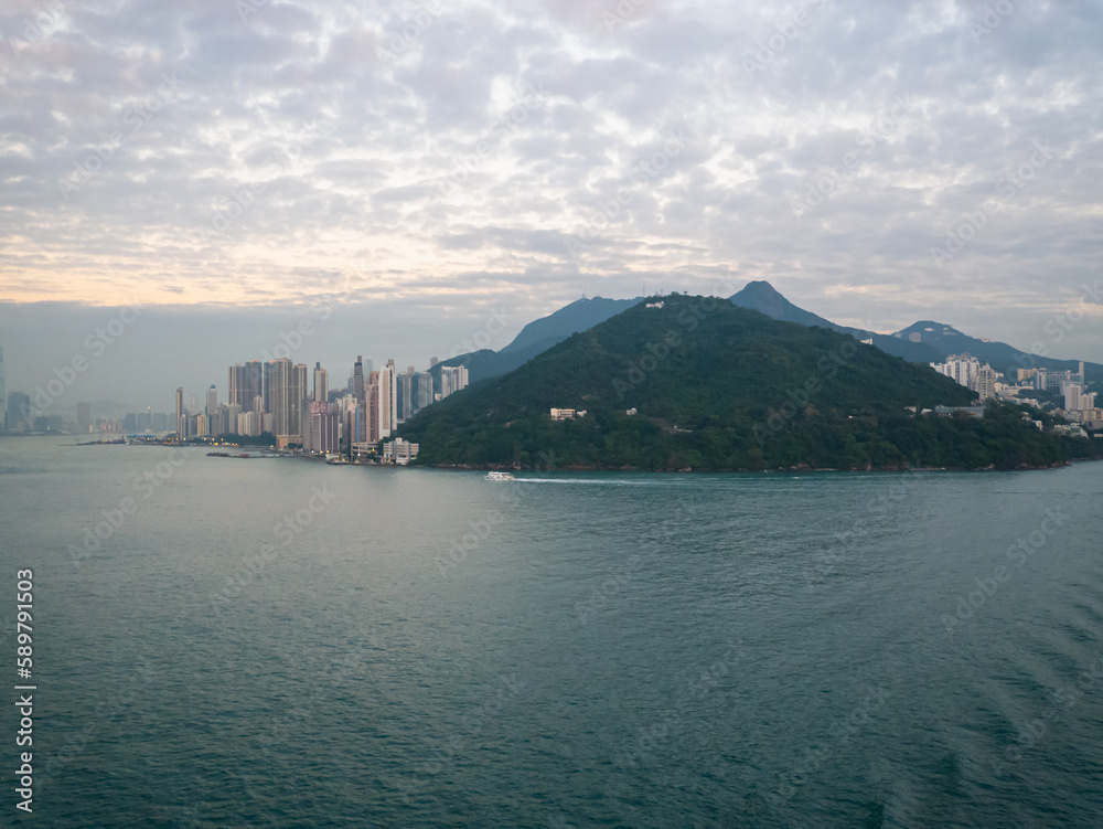Naklejka premium View of Hong Kong Island living quarter cityscape with many skyscraper buildings from sea.