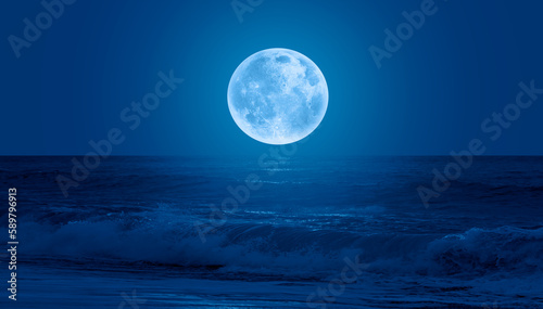 Super Full Moon. Colorful sky with cloud and bright full moon over seascape  Elements of this image furnished by NASA 