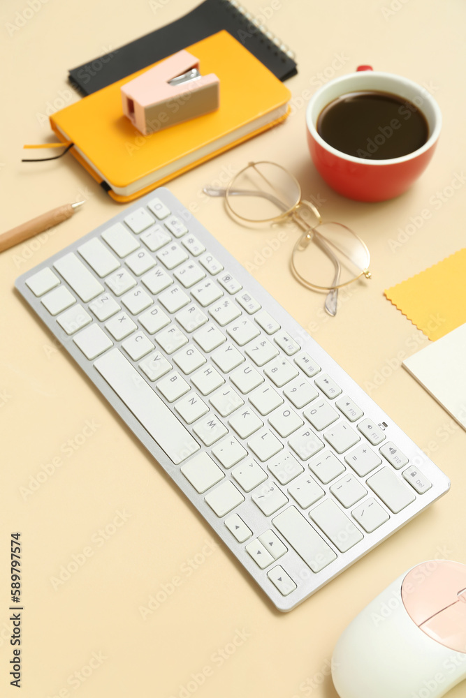 Composition with keyboard, coffee, calculator and notepad on beige background Composition with keyboard, coffee, calculator and notepad on beige background