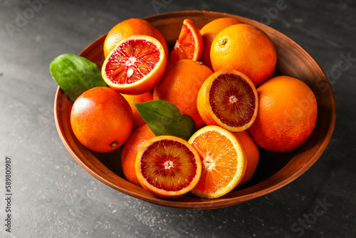 Bowl with delicious blood orange fruits on black grunge table © Pixel-Shot