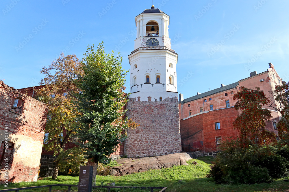 Clock tower in Vyborg, Russia. Cityscape with old stone houses in the historic center.