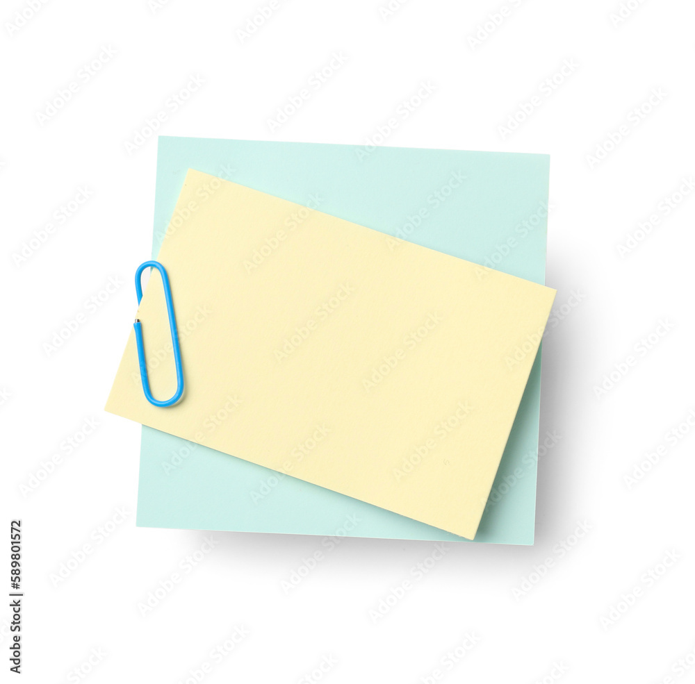 Yellow and blue sticky notes with paper clip on white background Yellow and blue sticky notes with paper clip on white background