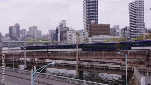 Japanese Trains Passing Each other at Kyobashi Bridge, Osaka in Spring photo