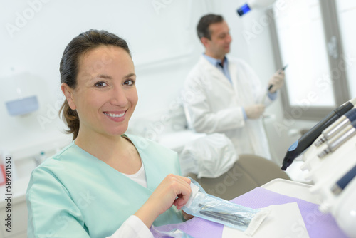 young female dentist assistant smiling looking at the camera