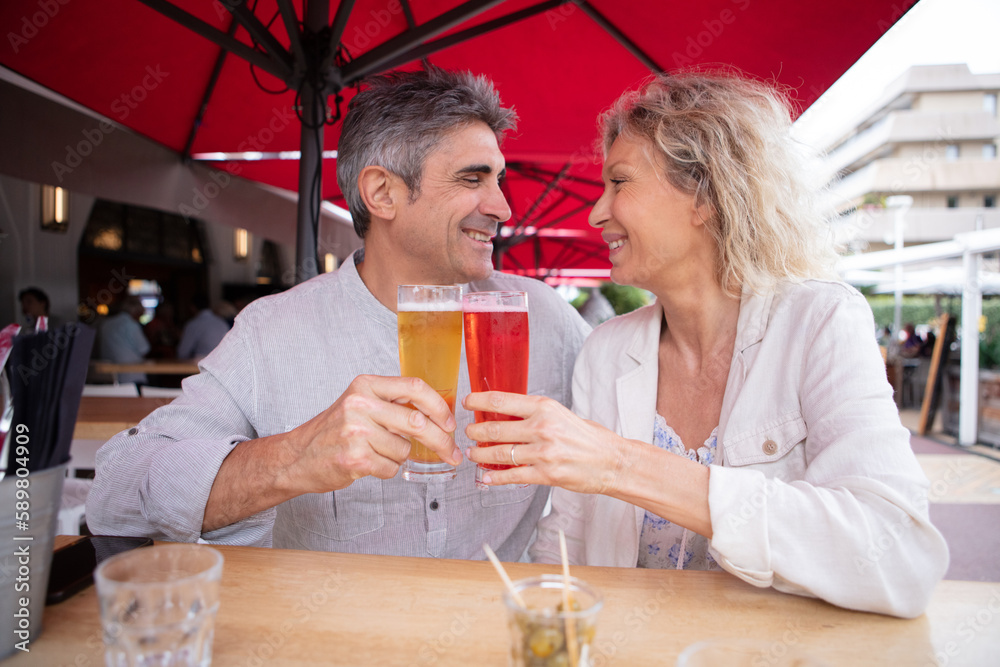 a portrait of a middle aged couple having a beer a portrait of a middle aged couple having a beer