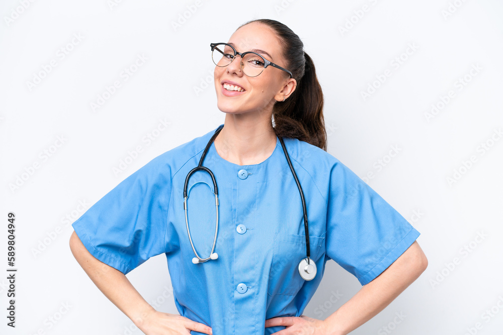 Young caucasian surgeon doctor woman isolated on white background posing with arms at hip and smiling Young caucasian surgeon doctor woman isolated on white background posing with arms at hip and smiling