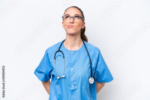 Young caucasian surgeon doctor woman isolated on white background and looking up