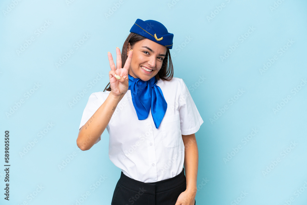 Airplane stewardess caucasian woman isolated on blue background happy and counting three with fingers Airplane stewardess caucasian woman isolated on blue background happy and counting three with fingers