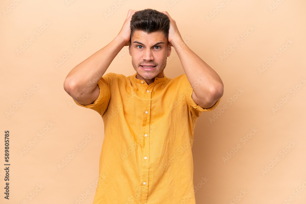Young caucasian man isolated on beige background doing nervous gesture Young caucasian man isolated on beige background doing nervous gesture