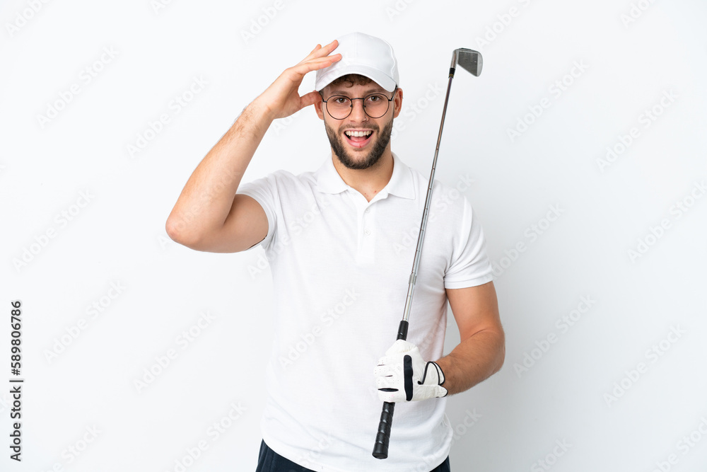 Handsome young man playing golf isolated on white background with surprise expression Handsome young man playing golf isolated on white background with surprise expression