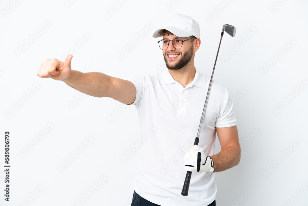 Handsome young man playing golf isolated on white background giving a thumbs up gesture Handsome young man playing golf isolated on white background giving a thumbs up gesture