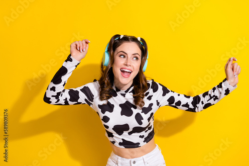 photo of funky positive girl in black spotted outfit wear wireless headset listen rock pop melody isolated shine color background