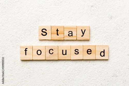 stay focused word written on wood block. stay focused text on table, concept