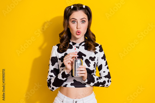 Photo of adorable impressed girl wear cow skin shirt drinking coca cola coke isolated yellow color background