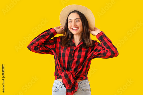 Young woman on yellow backg...