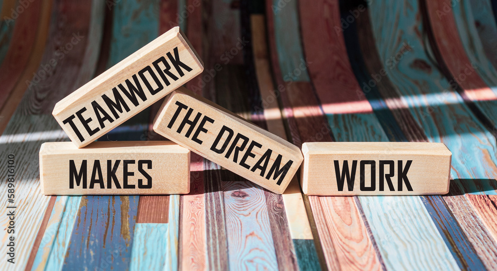 Fototapeta premium Concept words TMDW Teamwork make a dream job on a wooden block on a beautiful vintage background. Teamwork Business TMWD creates a dream job concept.