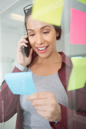 young girl is holding sticky notes in a glass office