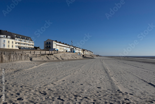 View of the beach and seafront at Fort-Mahon-Plage in the Somme department of Hauts-de-France in Northern France. Beautiful sunny spring evening with clear blue sky. Copy space above.