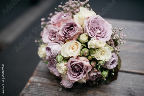 Closeup of a wedding bouquet with white and violet roses, blurred background