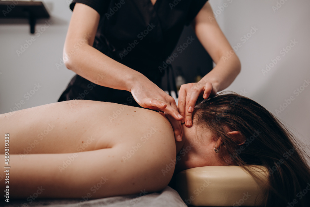 Fototapeta premium massage of neck for woman in spa salon