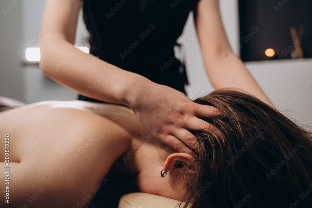 Fototapeta premium massage of neck for woman in spa salon