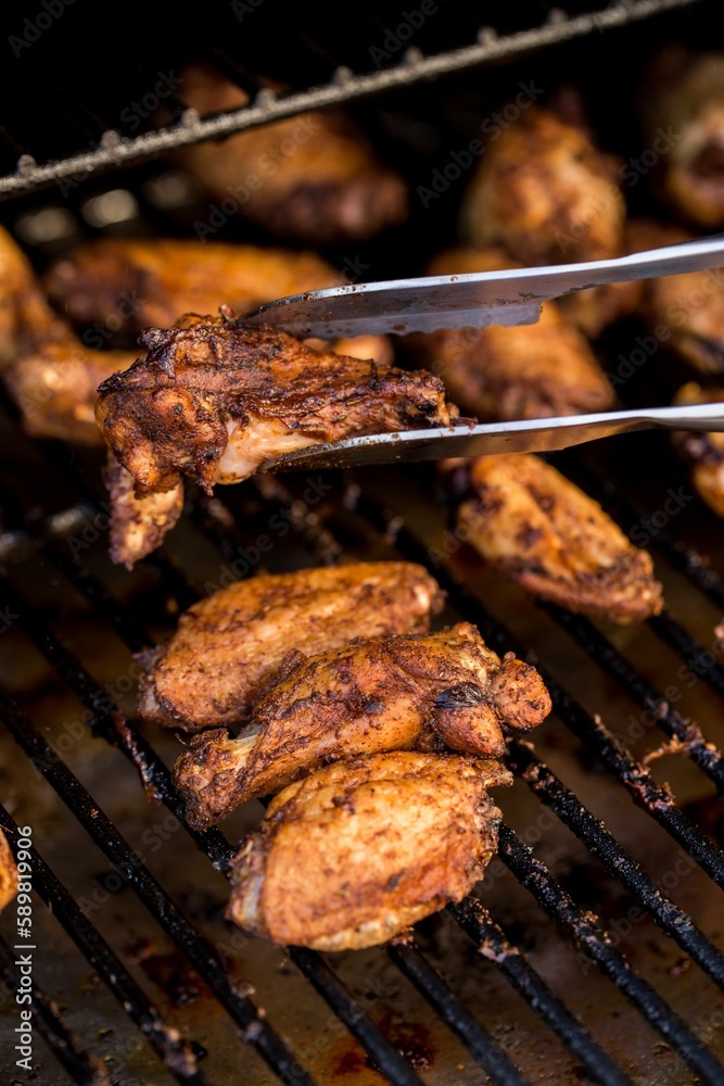 Closeup shot of tasty and homemade grilled chicken on the grill on the blurred background