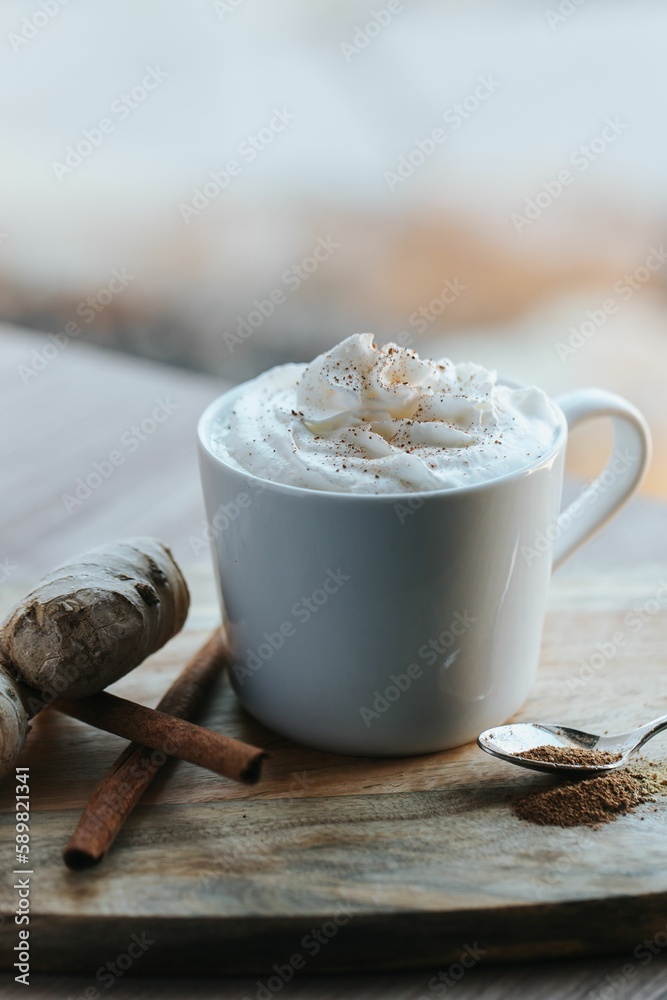 Vertical shot of a cup of hot chocolate on the wooden background Vertical shot of a cup of hot chocolate on the wooden background