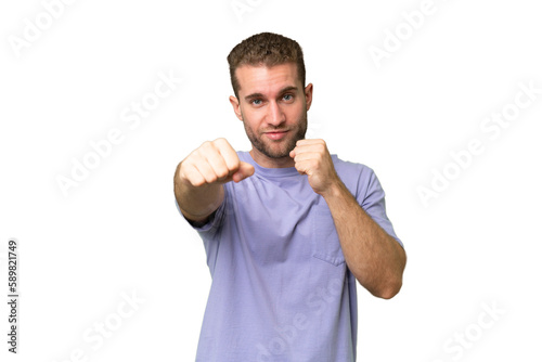 Young handsome caucasian man isolated on green chroma background with fighting gesture