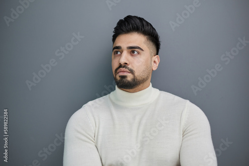 Portrait of stylish middle aged man posing on gray background © Katsiaryna